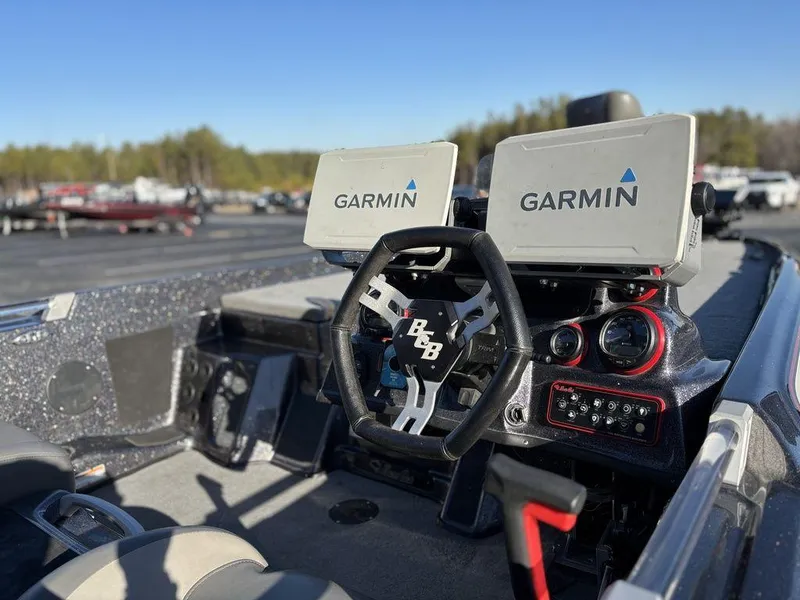 Slide: The Image of 2022 Bass Cat Cougar FTD boat dashboard with dual Garmin displays and steering wheel. - 6