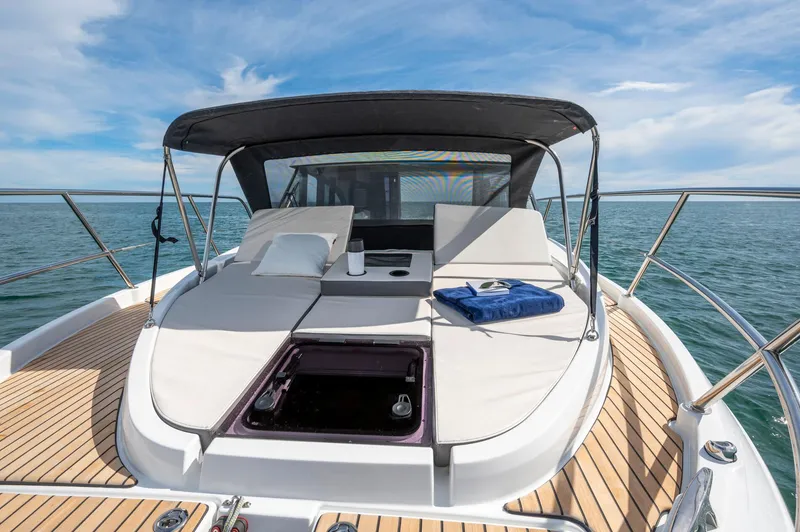 Slide: The Image of 2026 Beneteau Antares 11 OB yacht with sun deck and canopy on open water. - 11