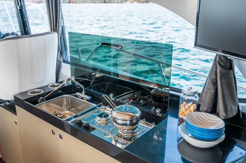 Slide: The Image of Modern kitchen area on 2026 Beneteau Antares 11 OB yacht with ocean view. - 24