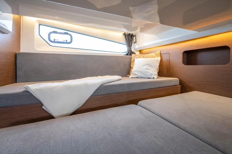 Slide: The Image of 2026 Beneteau Antares 11 OB cabin interior with modern design and cozy seating. - 29