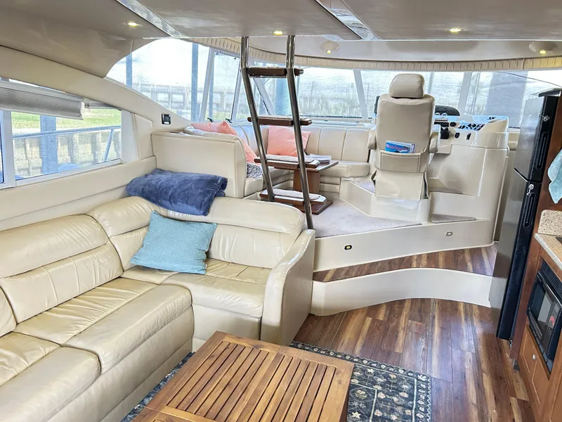 Slide: The Image of Luxurious interior of 2004 Cruisers Yachts 5000 Sedan Sport with leather seating and wood accents. - 11