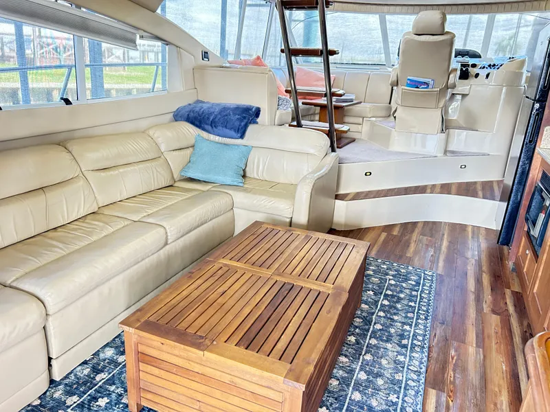 Slide: The Image of Luxurious 2004 Cruisers Yachts 5000 Sedan Sport interior with leather seating and wooden accents. - 14