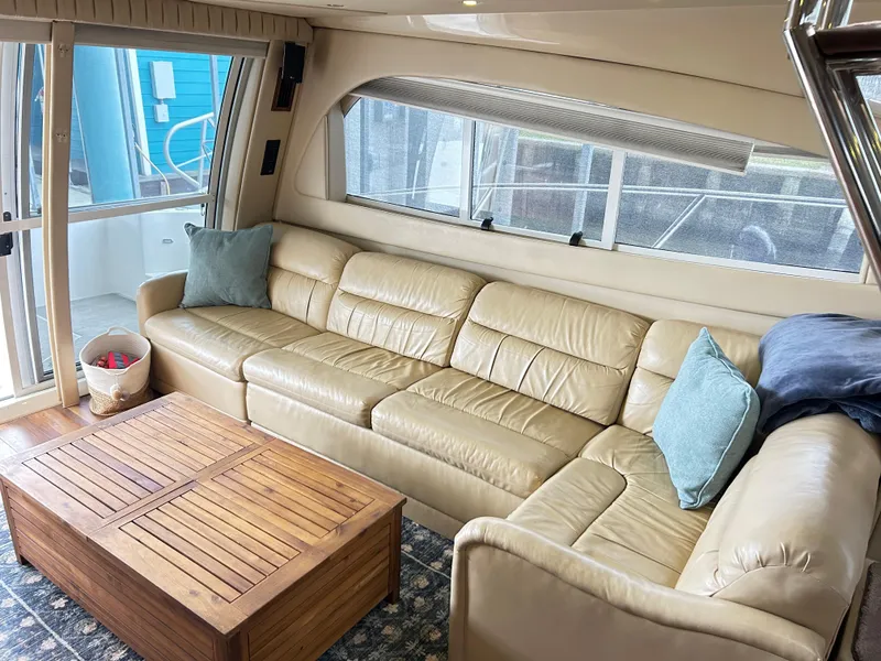 Slide: The Image of Luxurious interior of 2004 Cruisers Yachts 5000 Sedan Sport with beige leather seating. - 16