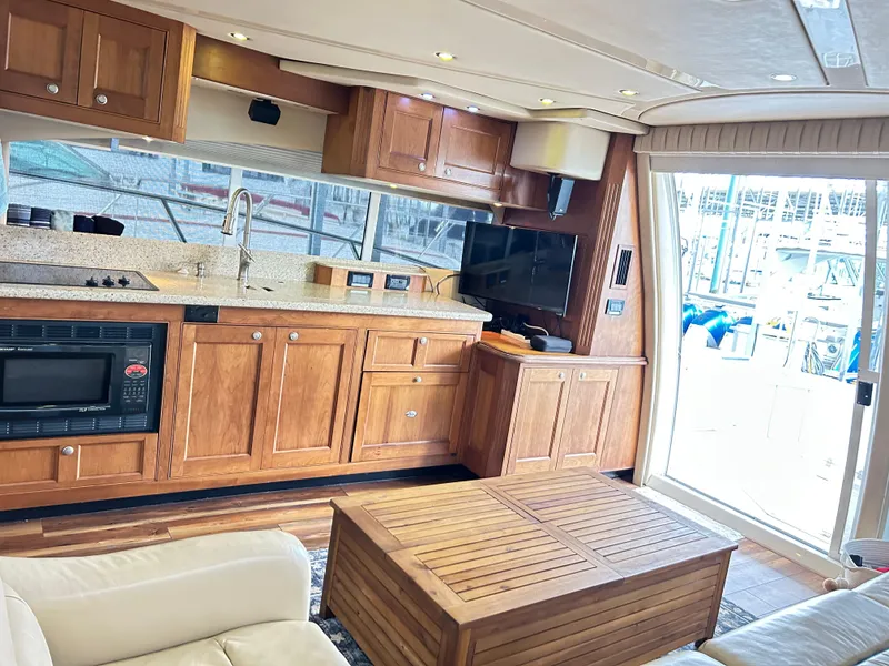 Slide: The Image of Luxurious interior of 2004 Cruisers Yachts 5000 Sedan Sport with wooden cabinetry and modern amenities. - 18