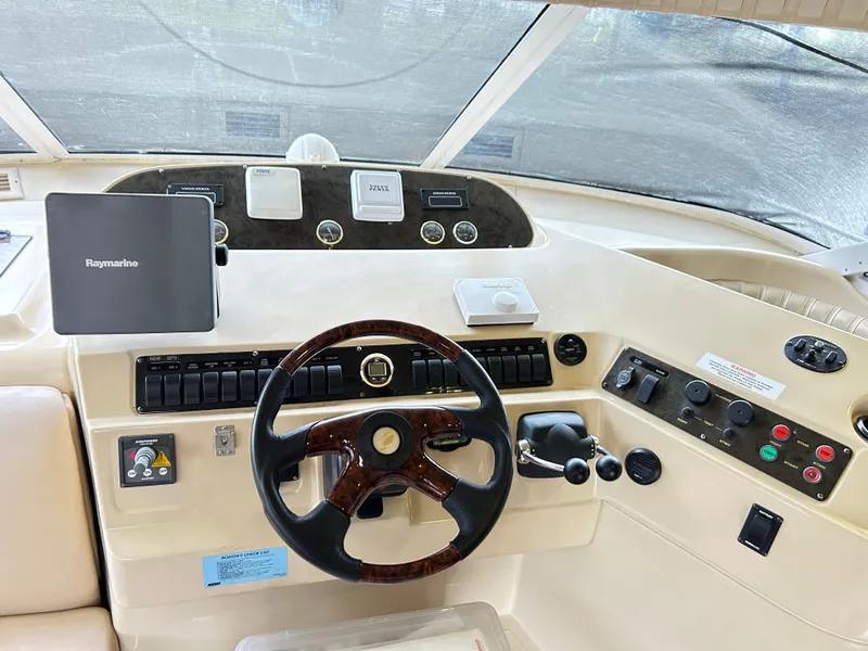 Slide: The Image of 2004 Cruisers Yachts 5000 Sedan Sport helm with steering wheel and navigation controls. - 21