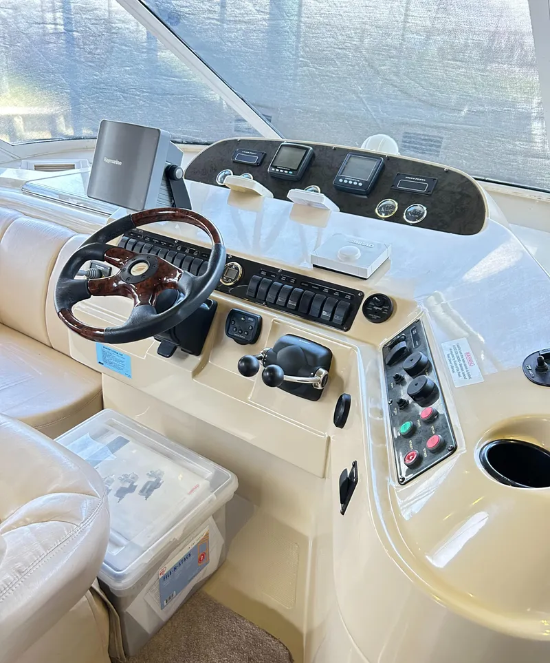 Slide: The Image of 2004 Cruisers Yachts 5000 Sedan Sport helm with steering wheel and control panel. - 24