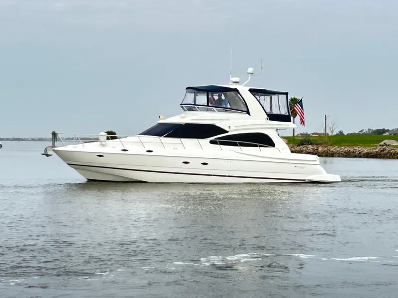 Slide: The Image of 2004 Cruisers Yachts 5000 Sedan Sport cruising on calm waters, side view. - 3