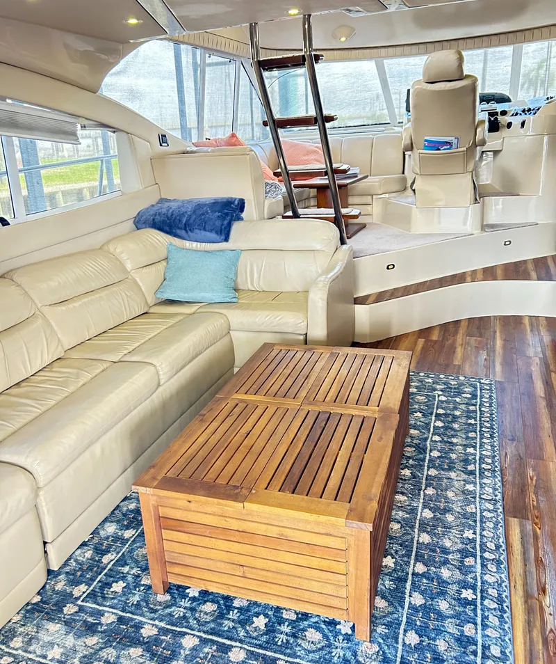 Slide: The Image of Luxurious 2004 Cruisers Yachts 5000 Sedan Sport interior with leather seating and wooden table. - 31