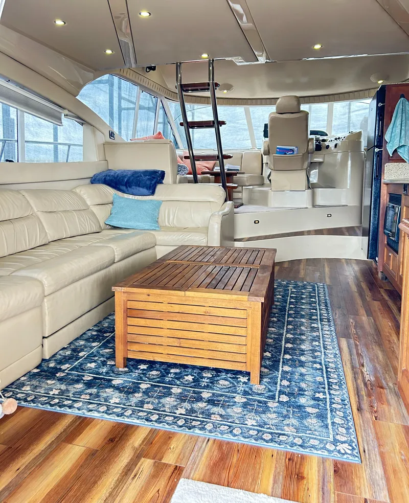 Slide: The Image of Luxurious interior of 2004 Cruisers Yachts 5000 Sedan Sport with leather seating and wooden accents. - 32