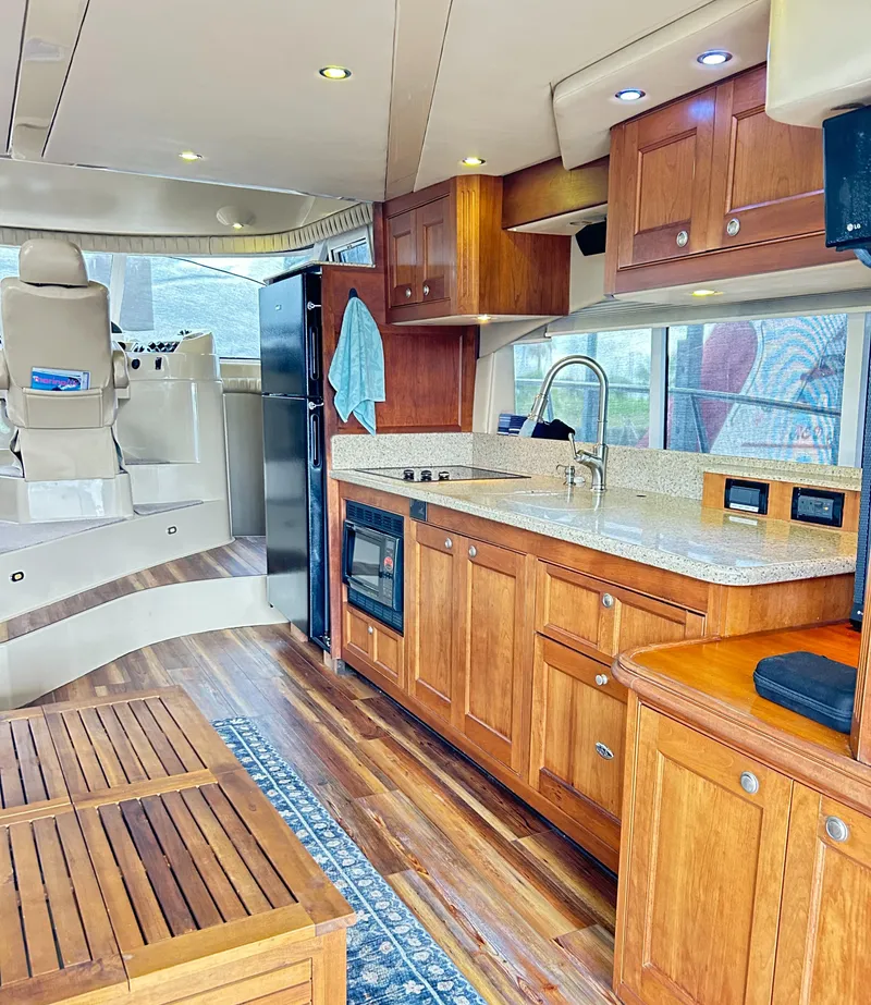 Slide: The Image of 2004 Cruisers Yachts 5000 Sedan Sport interior with wood cabinetry and modern kitchen amenities. - 35
