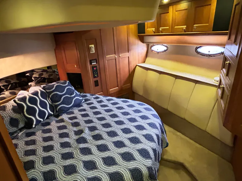 Slide: The Image of Luxurious cabin interior of 2004 Cruisers Yachts 5000 Sedan Sport with cozy bedding. - 43
