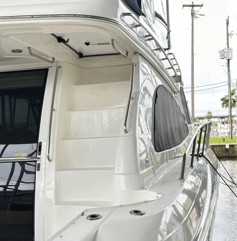 Slide: The Image of 2004 Cruisers Yachts 5000 Sedan Sport, sleek exterior with stairs and railing. - 8