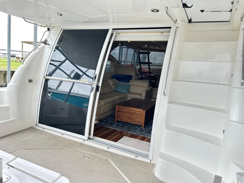 Slide: The Image of 2004 Cruisers Yachts 5000 Sedan Sport interior with sliding doors and comfortable seating. - 10