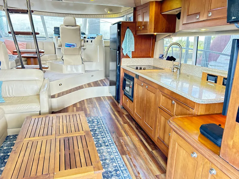 Slide: The Image of Luxurious 2004 Cruisers Yachts 5000 Sedan Sport interior with modern kitchen and seating area. - 12