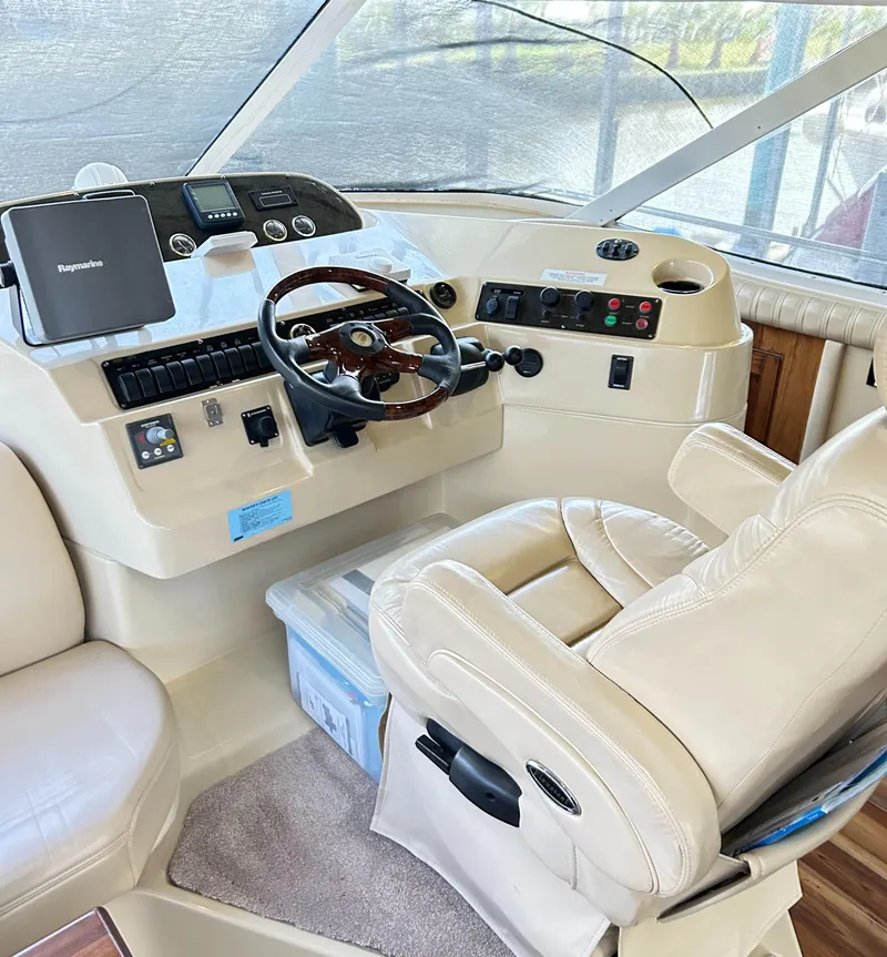 Slide: The Image of 2004 Cruisers Yachts 5000 Sedan Sport helm with leather seating and modern controls. - 28