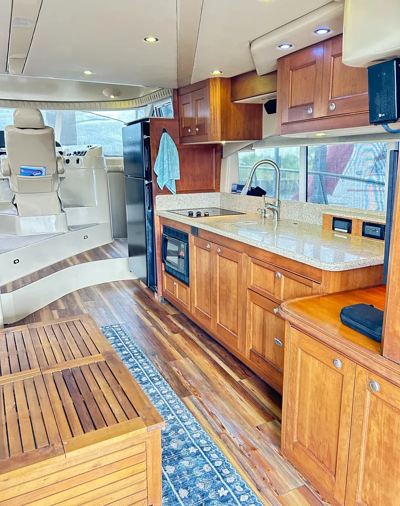 Slide: The Image of Luxurious 2004 Cruisers Yachts 5000 Sedan Sport interior with wood cabinetry and modern amenities. - 36