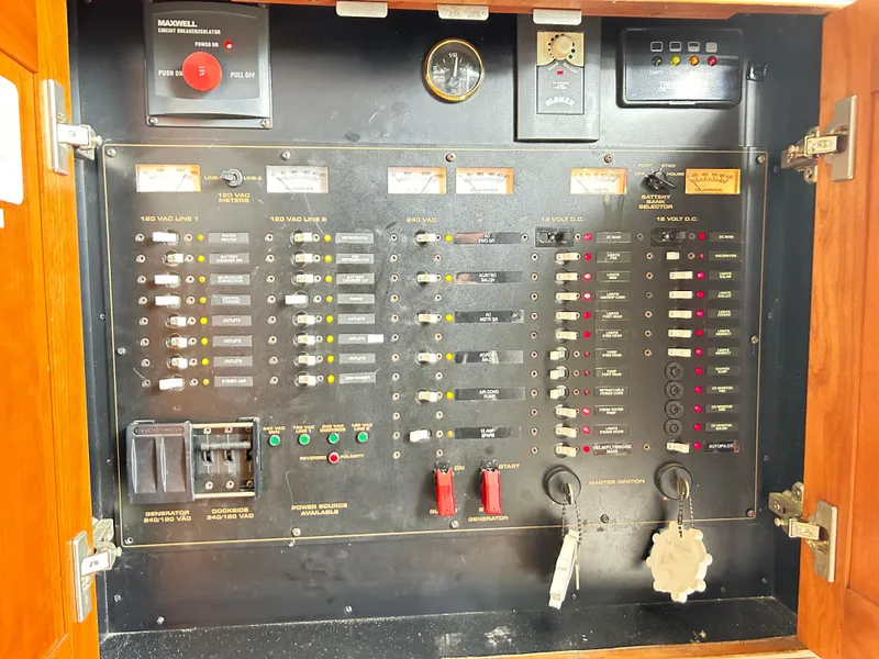 Slide: The Image of Electrical panel of a 2004 Cruisers Yachts 5000 Sedan Sport, featuring switches and gauges. - 42