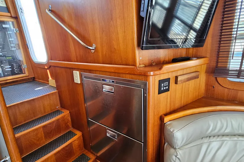Slide: The Image of Interior of 2002 Nordhavn Trawler with wooden paneling, stairs, and built-in appliances. - 13