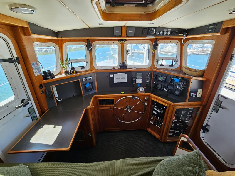 Slide: The Image of Pilothouse of a 2002 Nordhavn Trawler with navigation equipment and panoramic windows. - 19