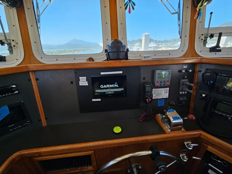 Slide: The Image of 2002 Nordhavn Trawler helm with Garmin navigation system and ocean view through windows. - 25