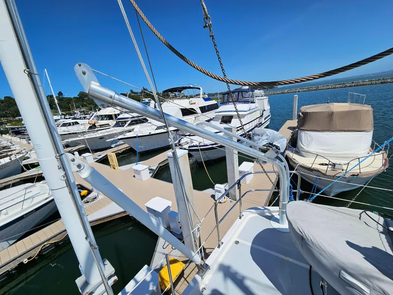 Slide: The Image of 2002 Nordhavn Trawler docked at marina, surrounded by other boats under clear blue sky. - 41