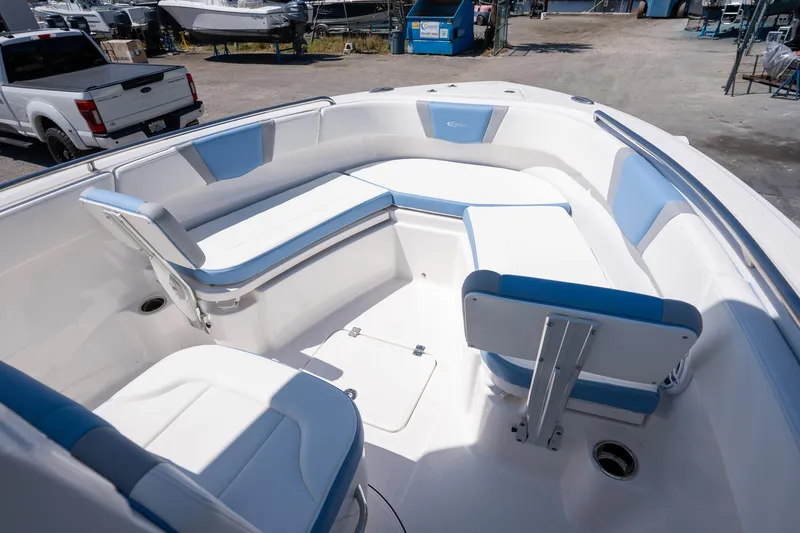 Slide: The Image of 2025 Robalo 232 Explorer boat interior with white and blue seating. - 13