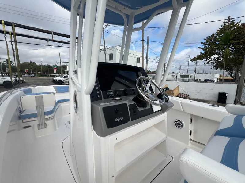 Slide: The Image of 2025 Robalo 232 Explorer boat interior with steering wheel and seating. - 15