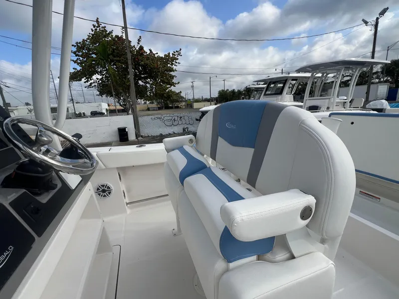 Slide: The Image of 2025 Robalo 232 Explorer boat interior with steering wheel and seating. - 18