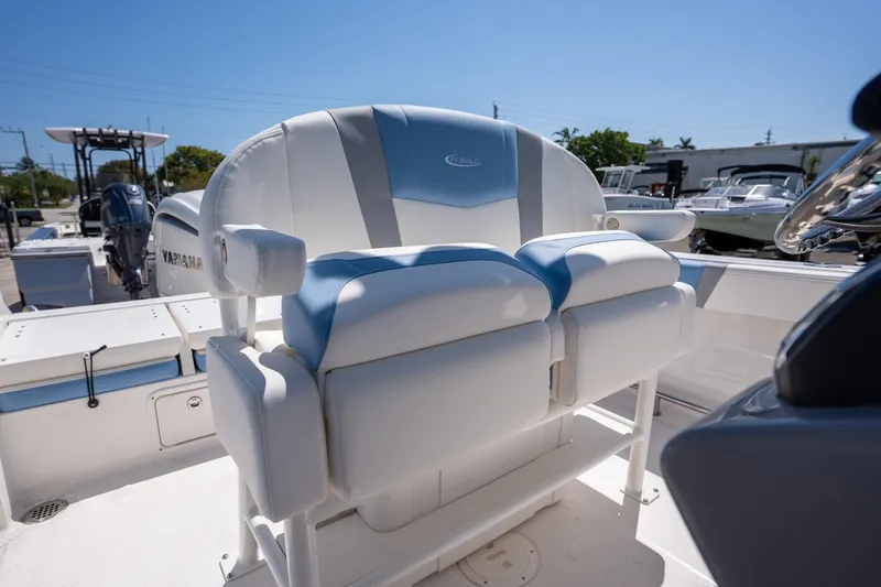 Slide: The Image of 2025 Robalo 232 Explorer boat seating with sleek white and blue design. - 19