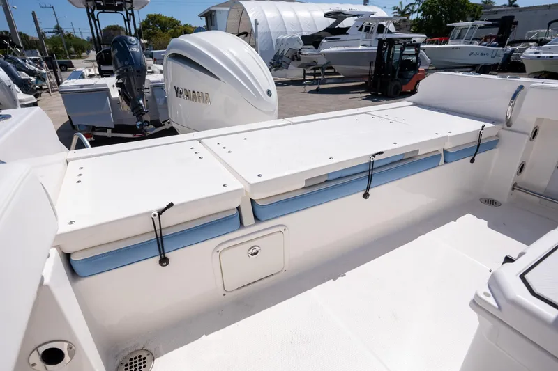 Slide: The Image of 2025 Robalo 232 Explorer boat deck with Yamaha engine, featuring storage compartments. - 20