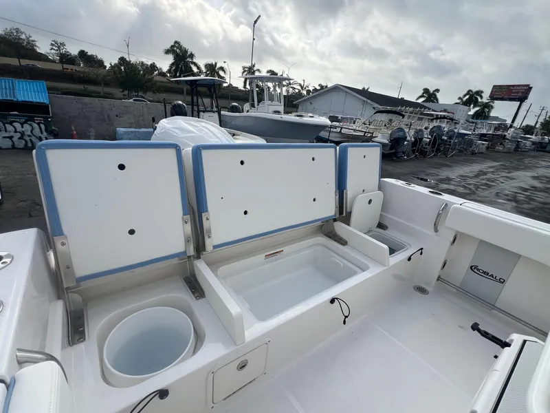 Slide: The Image of 2025 Robalo 232 Explorer boat interior with open storage compartments and seating. - 21
