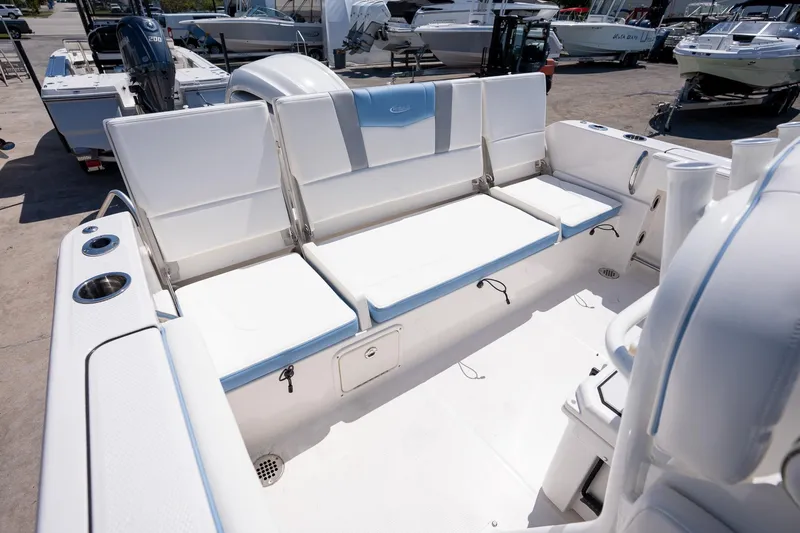 Slide: The Image of 2025 Robalo 232 Explorer boat interior with white seating and cup holders. - 22