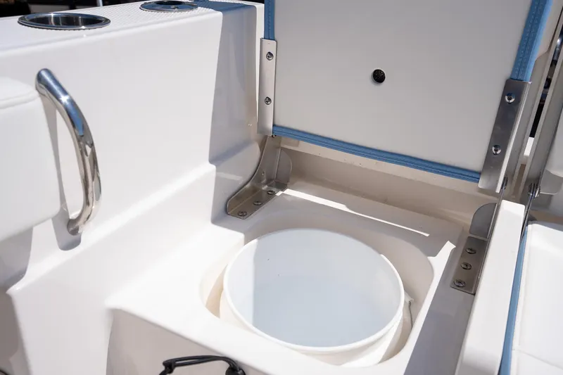 Slide: The Image of 2025 Robalo 232 Explorer boat interior with storage compartment and bucket. - 23