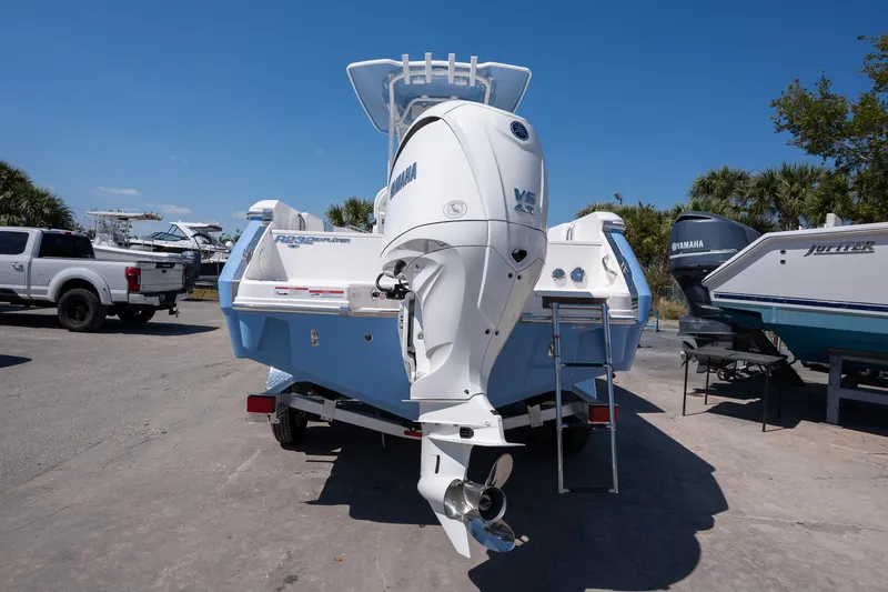 Slide: The Image of 2025 Robalo 232 Explorer boat with Yamaha V6 engine, parked on a trailer. - 26