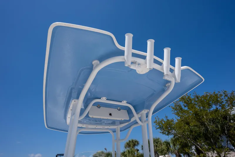 Slide: The Image of 2025 Robalo 232 Explorer boat top view with rod holders against clear blue sky. - 9