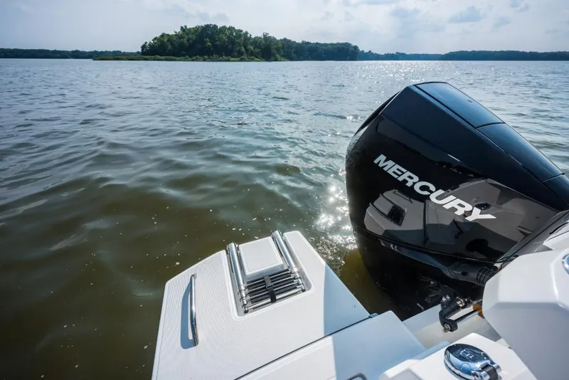 Slide: The Image of 2025 Beneteau Antares 7 with Mercury engine on calm water. - 11