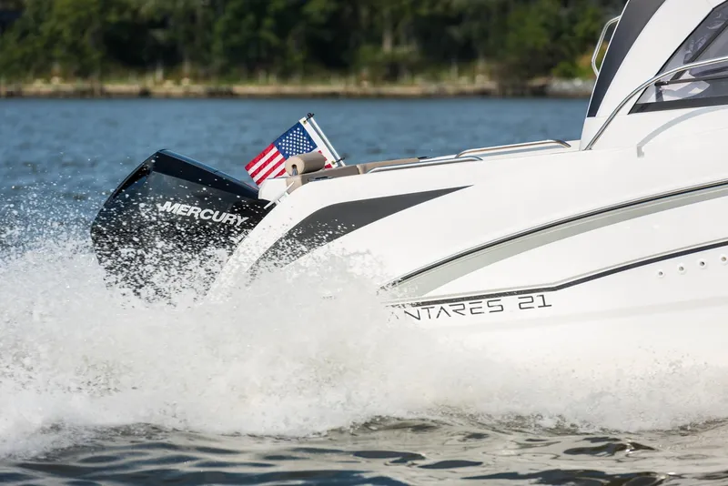 Slide: The Image of 2025 Beneteau Antares 7 boat cruising with Mercury engine on a lake. - 4