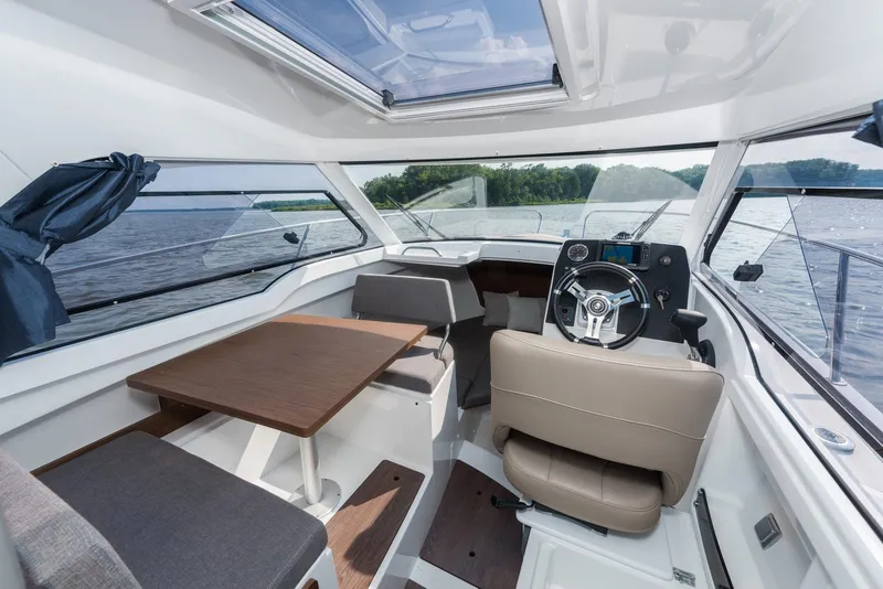 Slide: The Image of Interior of 2025 Beneteau Antares 7 boat with modern helm and seating. - 7