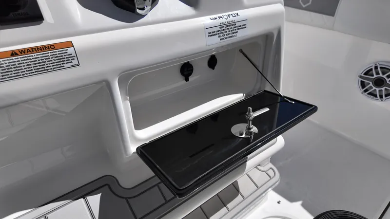 Slide: The Image of 2025 Sea Fox 288 Commander boat console with storage compartment and speaker. - 10