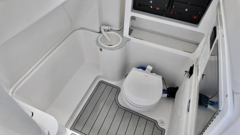 Slide: The Image of 2025 Sea Fox 288 Commander boat bathroom with toilet and storage compartments. - 26