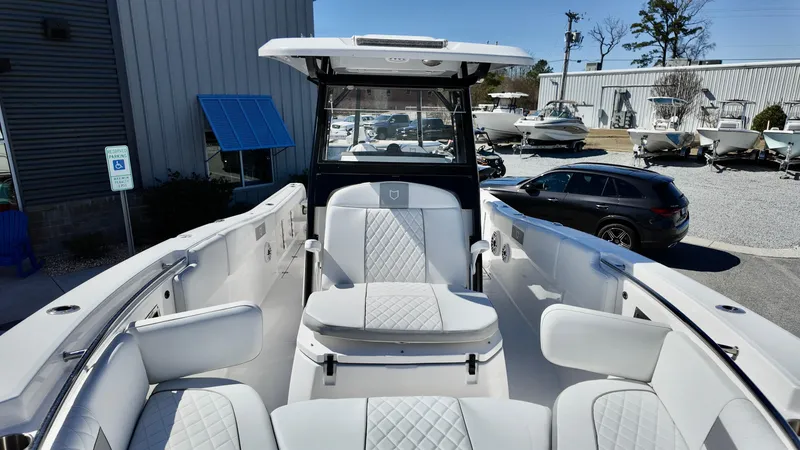 Slide: The Image of 2025 Sea Fox 288 Commander boat with luxurious seating and modern design in a marina setting. - 29