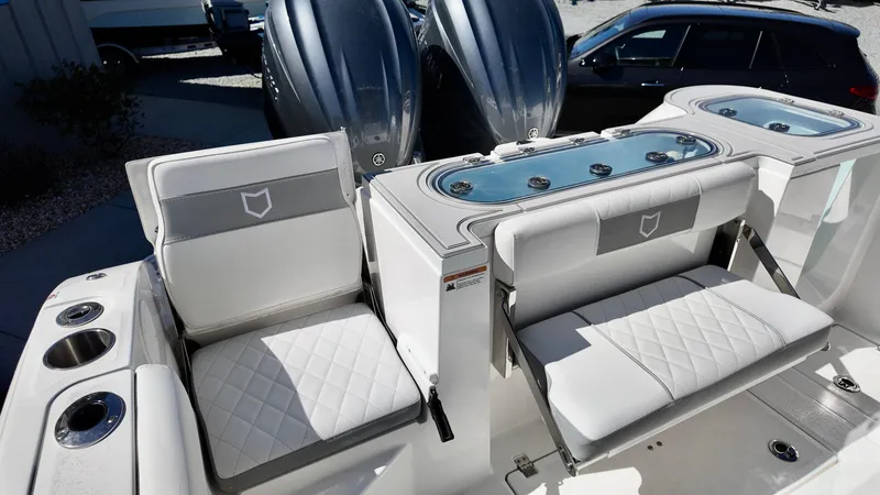 Slide: The Image of 2025 Sea Fox 288 Commander boat interior with cushioned seating and dual engines. - 30
