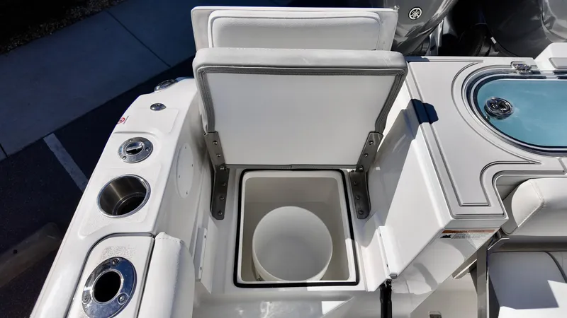 Slide: The Image of Sea Fox 288 Commander 2025 boat interior with open storage compartment and cup holders. - 31