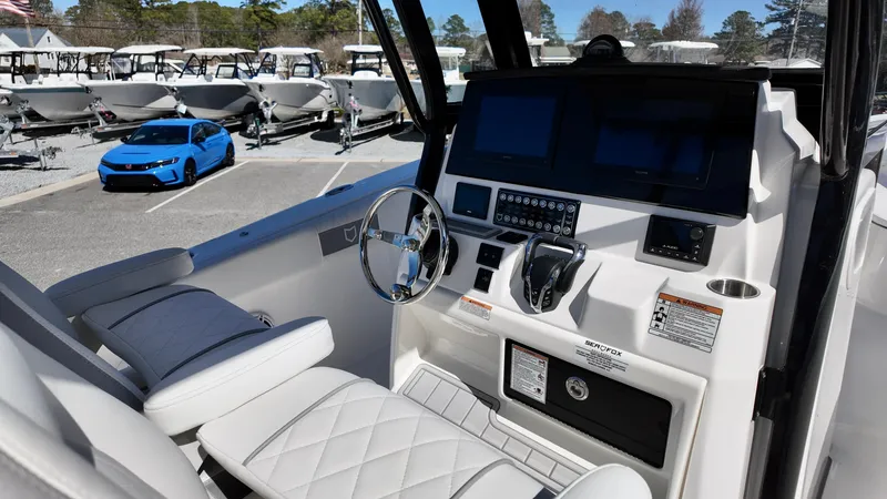 Slide: The Image of 2025 Sea Fox 288 Commander boat interior with modern dashboard and steering wheel. - 4