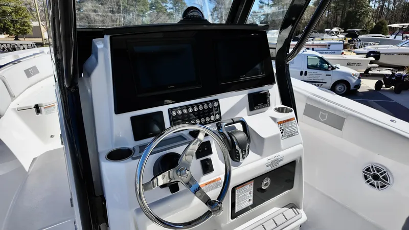 Slide: The Image of 2025 Sea Fox 288 Commander boat dashboard with steering wheel and control panel. - 5