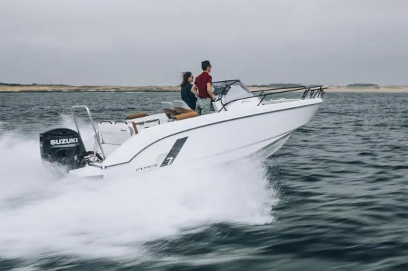 Slide: The Image of 2025 Beneteau Flyer 7 SUNdeck speeding on water with two passengers. - 6