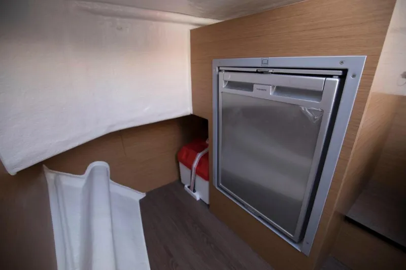Slide: The Image of 2025 Beneteau Flyer 8 SPACEdeck interior with compact fridge and modern design. - 18