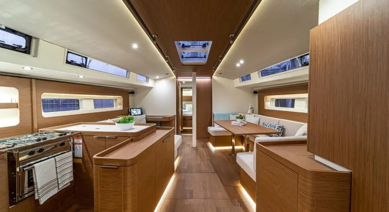 Slide: The Image of 2025 Beneteau Oceanis Yacht 54 interior, featuring modern wood finishes and elegant lighting. - 13