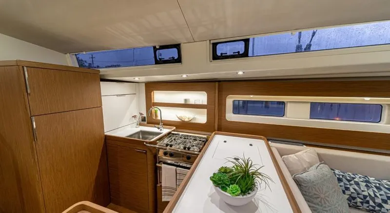 Slide: The Image of Luxurious interior of 2025 Beneteau Oceanis Yacht 54 with modern kitchen and seating area. - 14