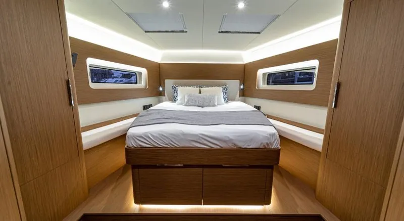 Slide: The Image of Luxurious cabin interior of 2025 Beneteau Oceanis Yacht 54 with modern design and cozy bedding. - 15